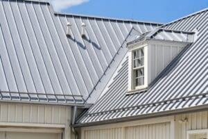 metal roofer installing panels on residential home